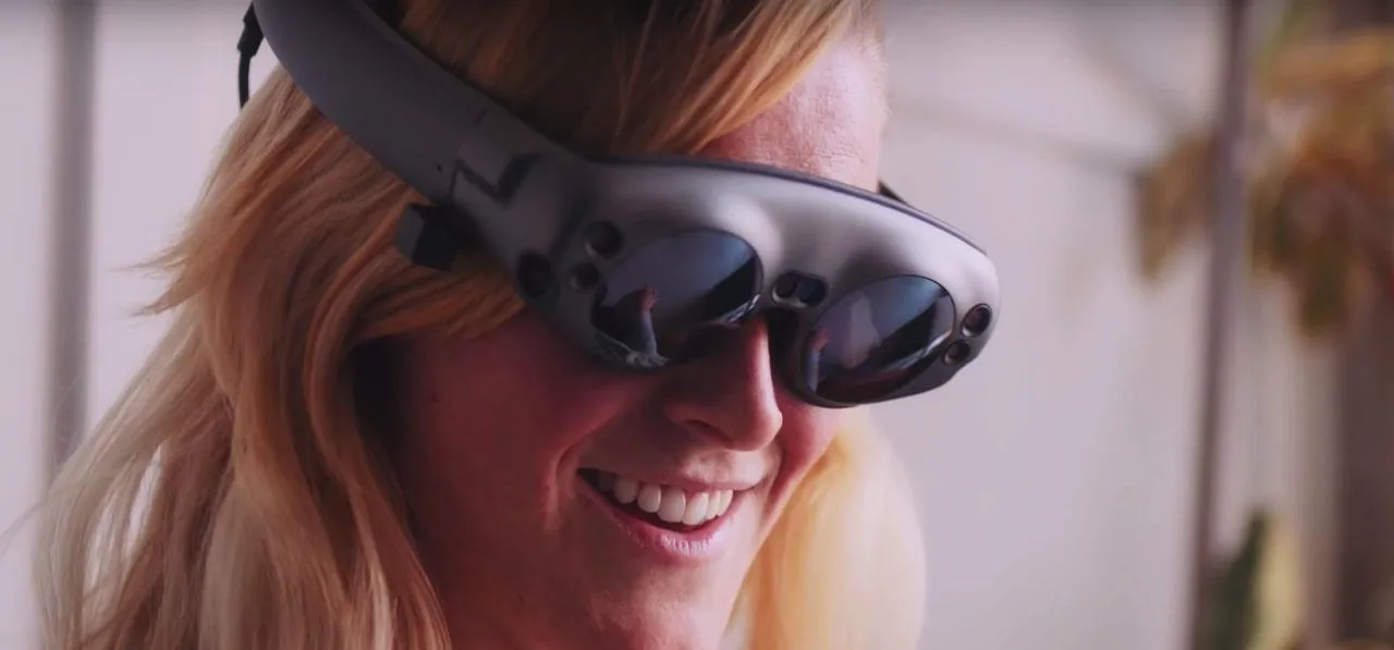 Woman smiling while wearing augmented reality glasses.