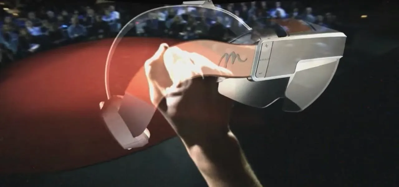 A person holds a pair of futuristic augmented reality glasses.