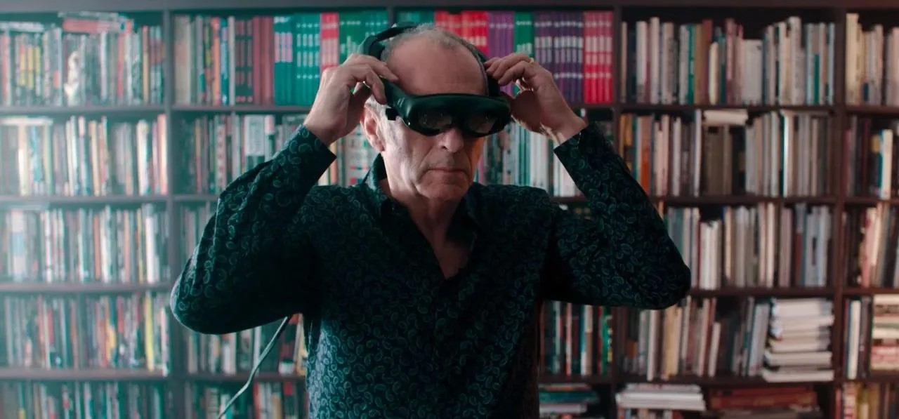 Man adjusting virtual reality headset in a library setting.