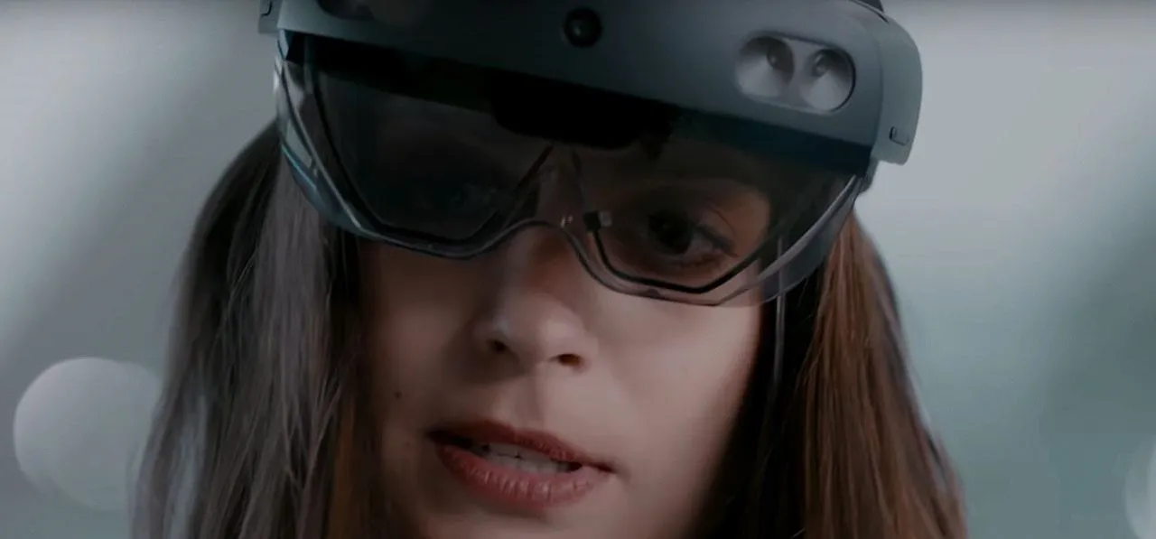 Woman using augmented reality headset in a professional setting.