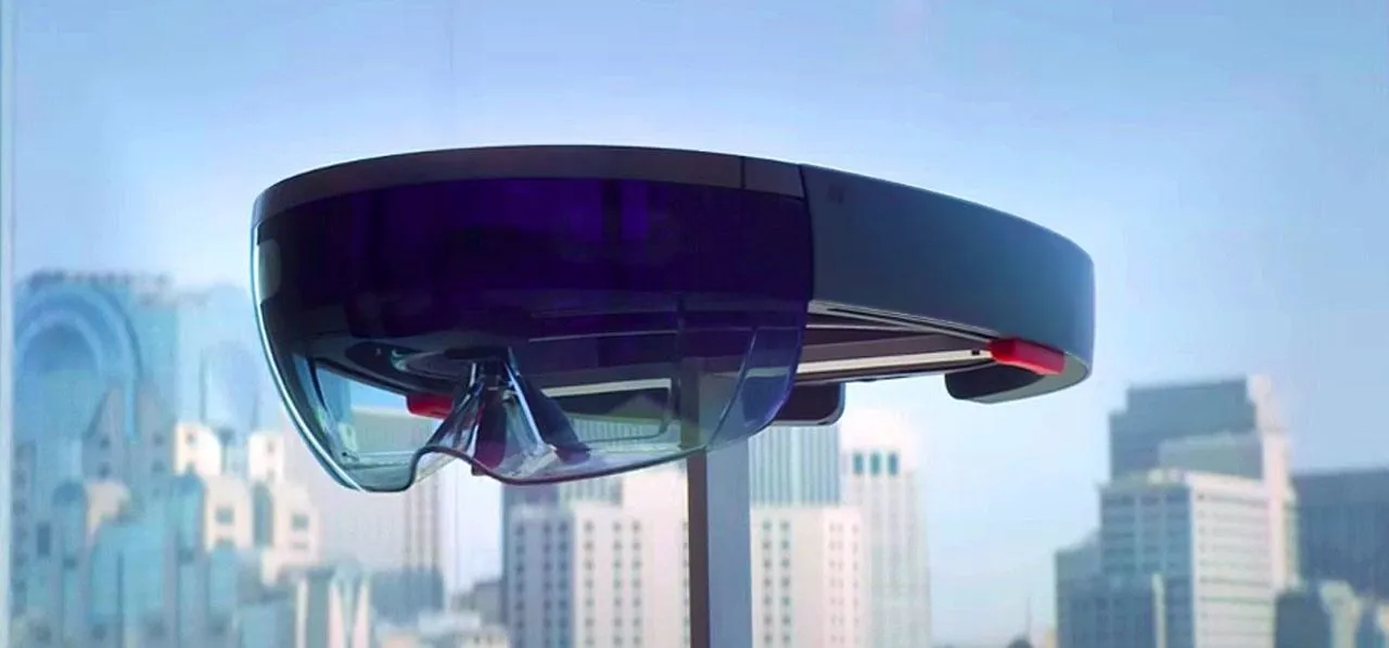 Virtual reality environment with floating geometric shapes and a projection screen.